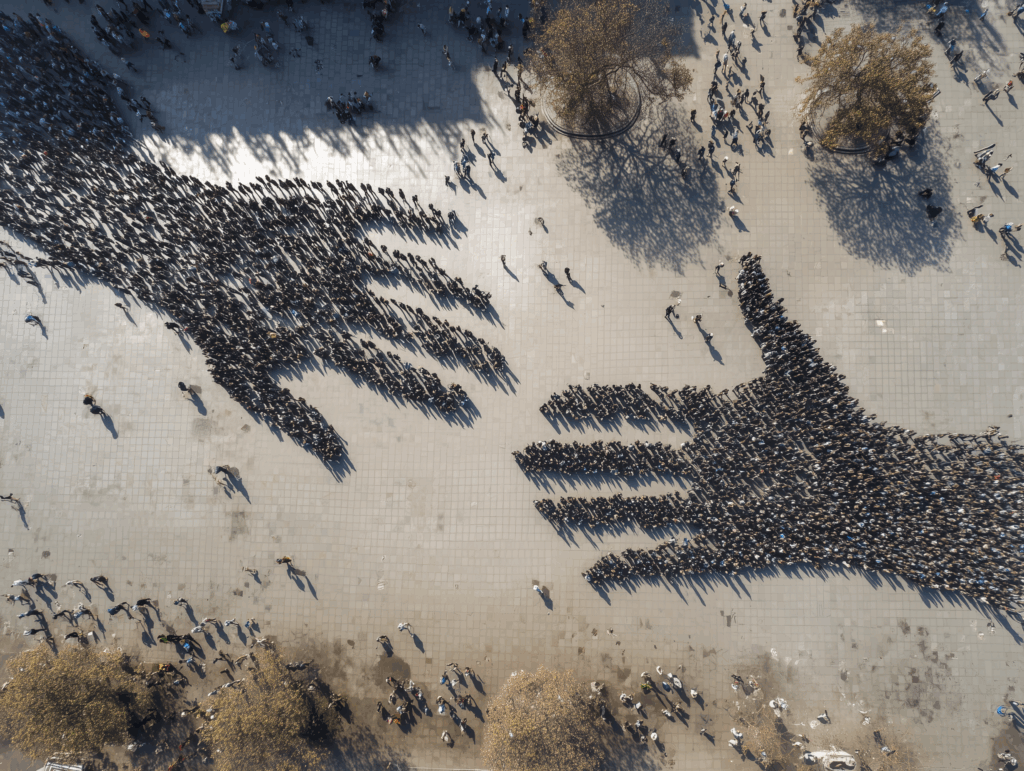Multicultural coworkers enthusiastically watching something on mobile device
